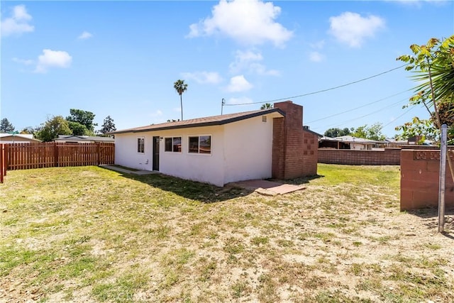 rear view of property with stucco siding