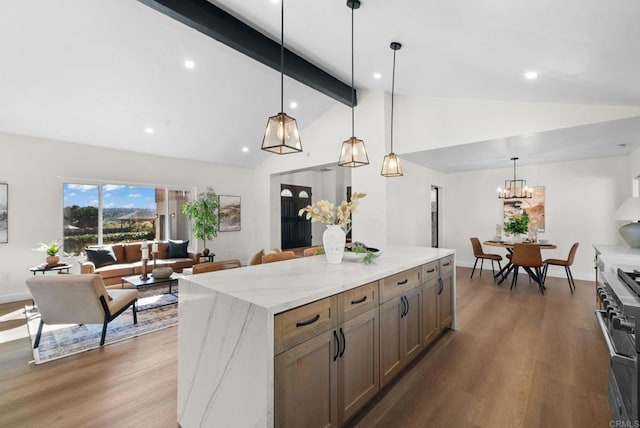 kitchen featuring high end stainless steel range oven, a notable chandelier, vaulted ceiling with beams, and wood finished floors