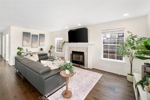 living room featuring recessed lighting, baseboards, dark wood finished floors, and a fireplace