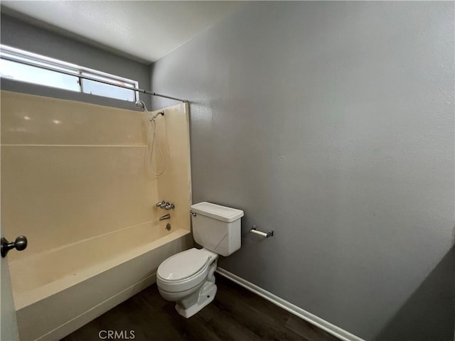 1121 E Whittier Ave, Hemet, CA 92543 - bathroom featuring baseboards, shower / bathing tub combination, toilet, and wood finished floors