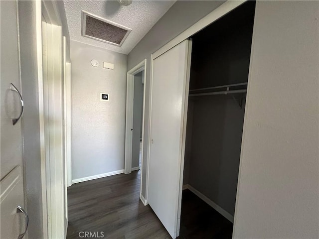 1121 E Whittier Ave, Hemet, CA 92543 - hall featuring visible vents, wood finished floors, baseboards, attic access, and a textured ceiling