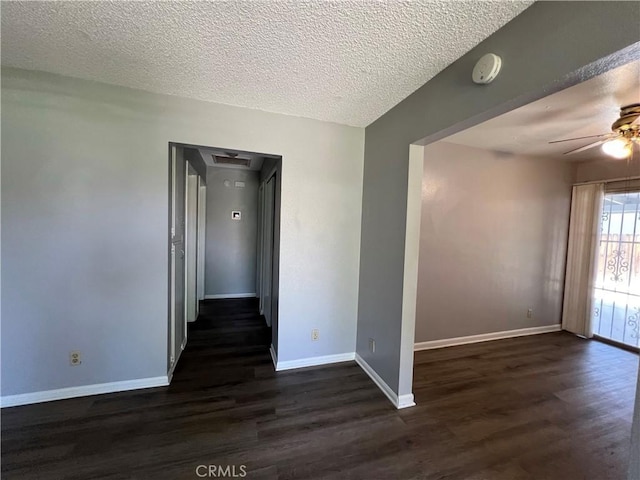 1121 E Whittier Ave, Hemet, CA 92543 - spare room featuring baseboards, ceiling fan, a textured ceiling, and dark wood-type flooring