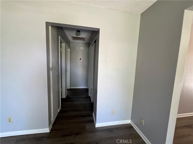 1121 E Whittier Ave, Hemet, CA 92543 - corridor with a textured ceiling, baseboards, dark wood finished floors, and visible vents