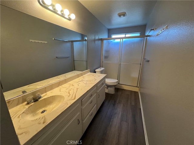1121 E Whittier Ave, Hemet, CA 92543 - full bath with toilet, a shower stall, wood finished floors, and vanity