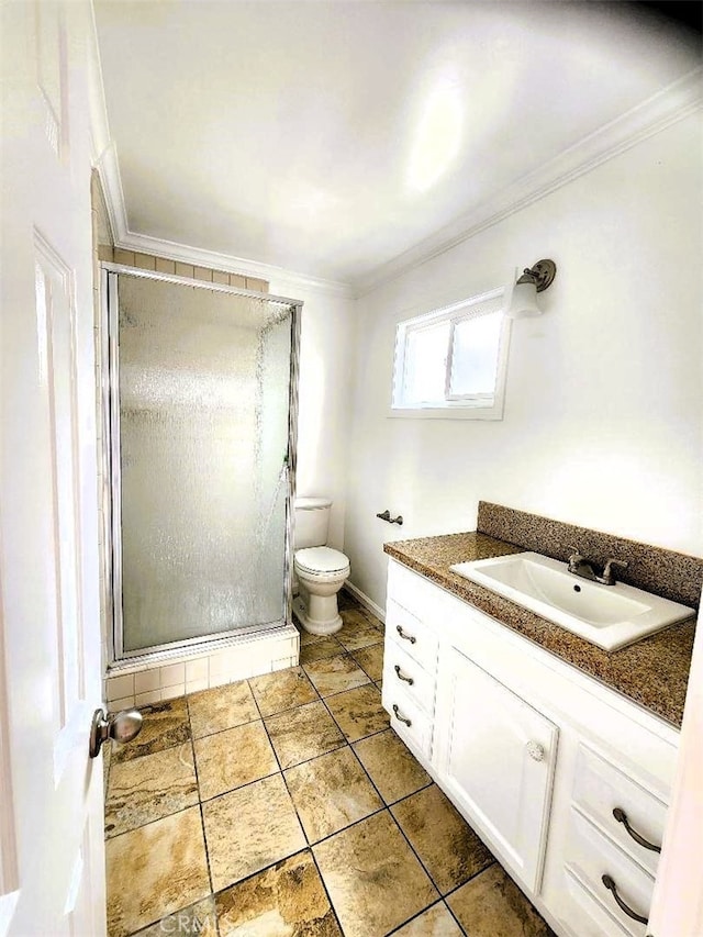 full bathroom featuring a shower stall, vanity, toilet, and crown molding