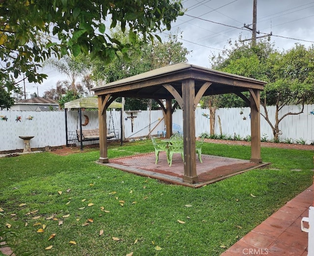 view of yard with a gazebo, a fenced backyard, and a patio area