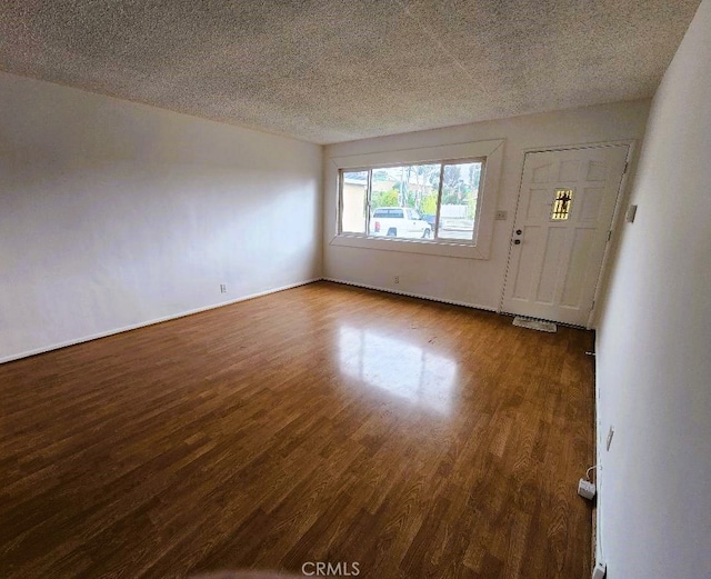 interior space featuring wood finished floors and a textured ceiling