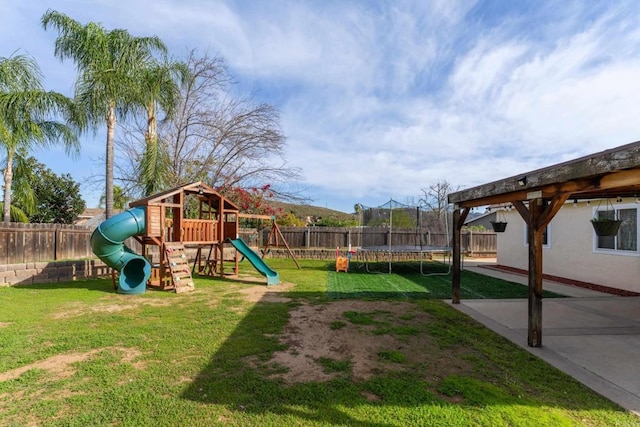 view of playground featuring a fenced backyard, a lawn, and a trampoline