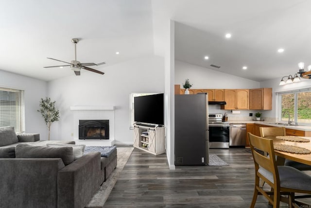 living room with recessed lighting, a fireplace, ceiling fan, and dark wood-style flooring