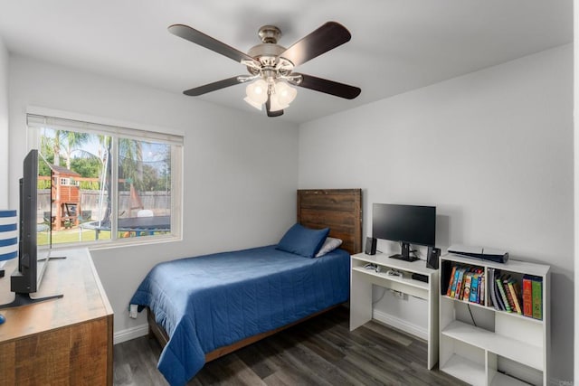 bedroom featuring ceiling fan, baseboards, and wood finished floors