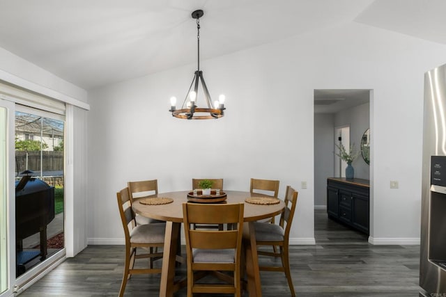 dining space featuring a notable chandelier, baseboards, dark wood-type flooring, and lofted ceiling