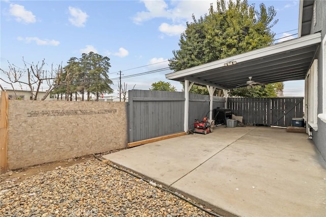 view of patio with a carport and fence