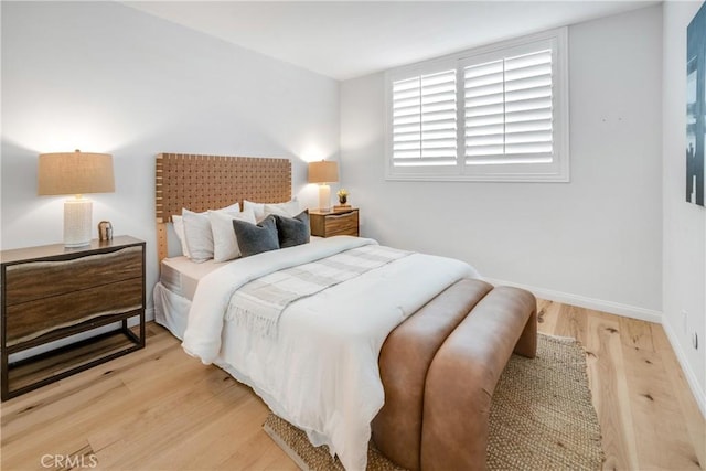 bedroom featuring light wood-type flooring and baseboards