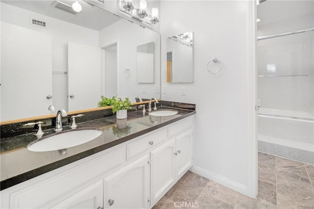 bathroom featuring double vanity, visible vents, and a sink