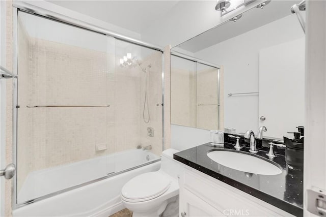 bathroom with bath / shower combo with glass door, vanity, and toilet