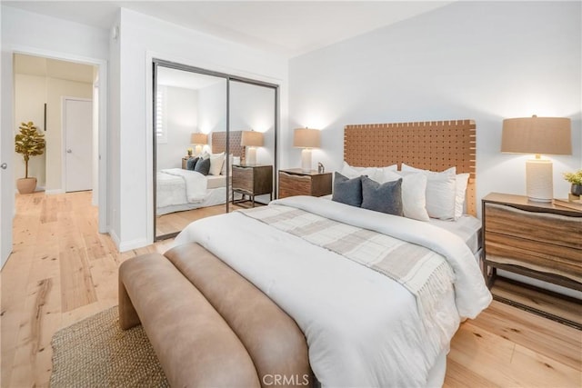 bedroom featuring a closet and light wood-style flooring