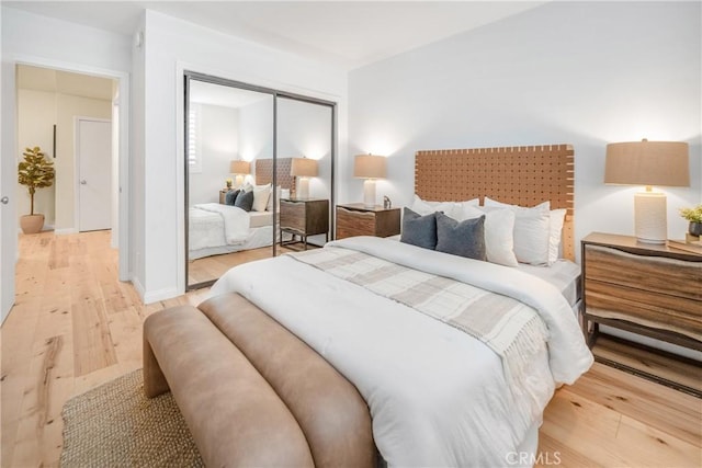bedroom featuring a closet and light wood-style floors