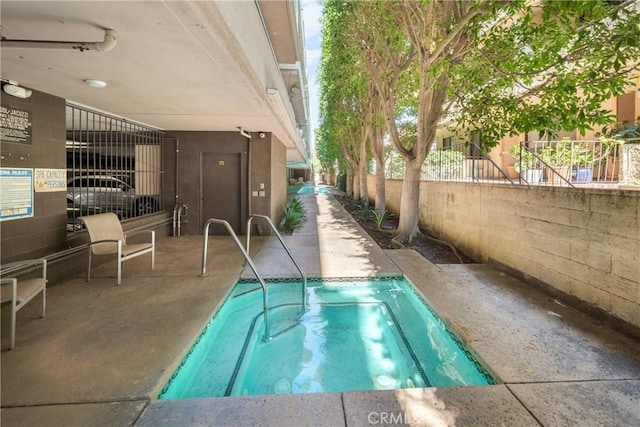 view of pool with a patio area and fence