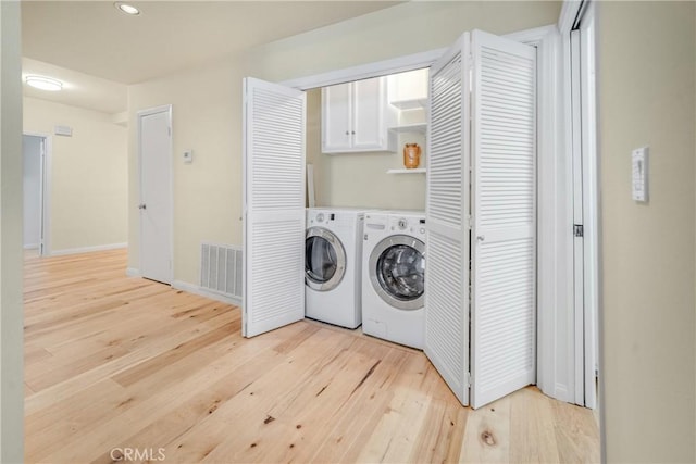 laundry area with visible vents, light wood-style flooring, recessed lighting, separate washer and dryer, and baseboards