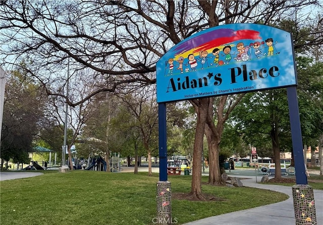 view of community with playground community and a lawn