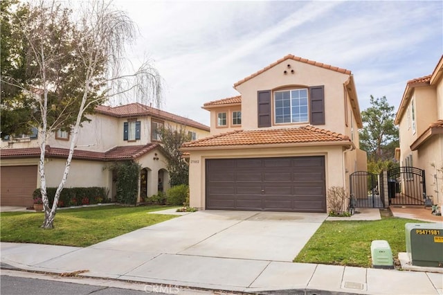 mediterranean / spanish-style house featuring a tiled roof, concrete driveway, stucco siding, a garage, and a gate