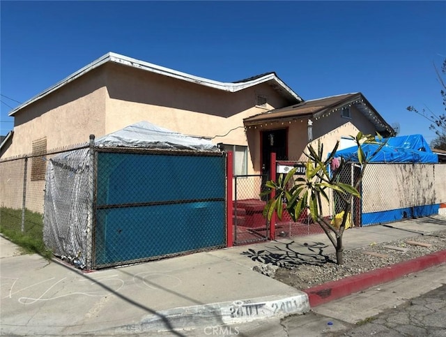 view of front of home with fence and stucco siding