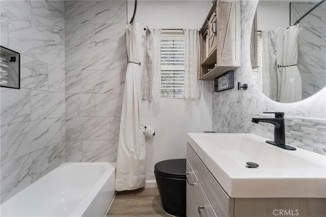 full bathroom with wood finished floors, toilet, shower / bath combo, and vanity