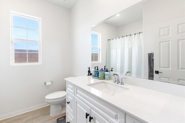 30981 Alister Ln, Winchester, CA 92596 - full bath with curtained shower, wood finished floors, toilet, vanity, and baseboards