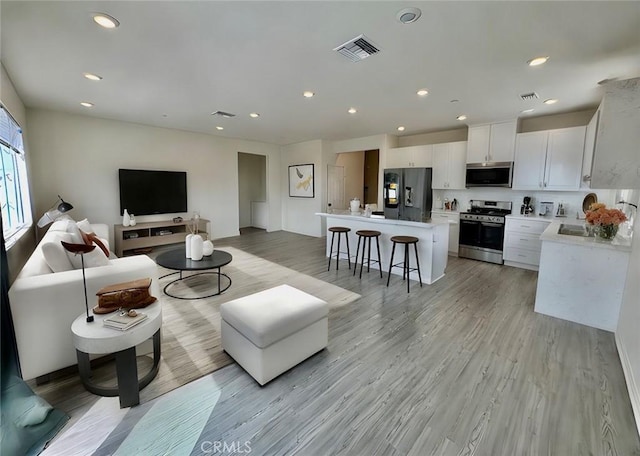 30981 Alister Ln, Winchester, CA 92596 - living area featuring recessed lighting, visible vents, and light wood-type flooring