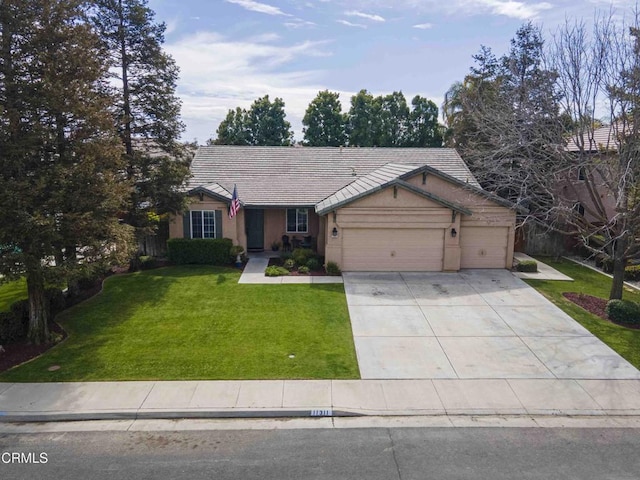 view of front of home with a tile roof, a front yard, stucco siding, driveway, and an attached garage