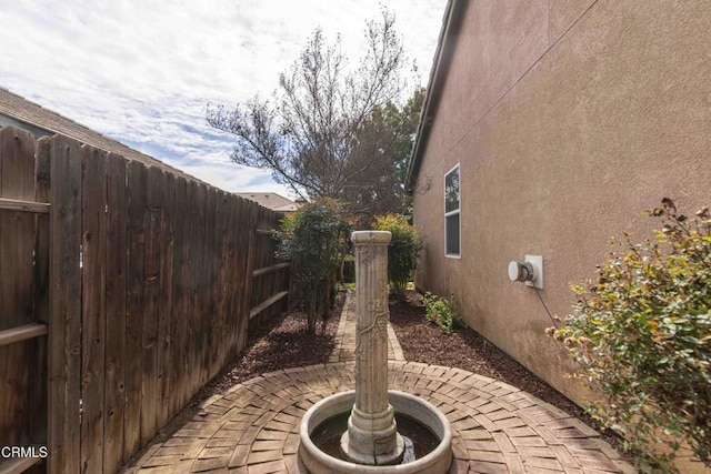 view of patio / terrace featuring fence