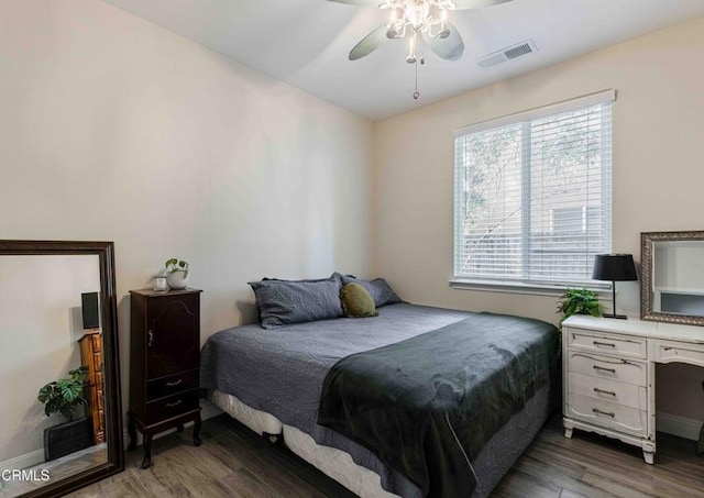 bedroom featuring a ceiling fan, wood finished floors, and visible vents