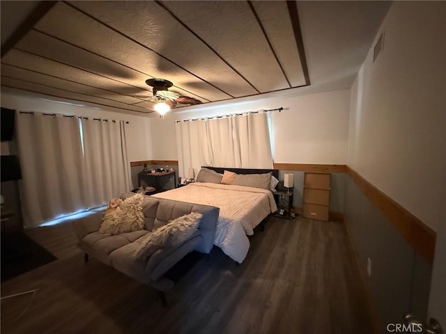 bedroom featuring wood finished floors, visible vents, and ceiling fan