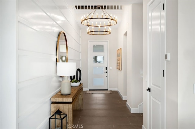 entryway featuring a chandelier, visible vents, dark wood-type flooring, and baseboards