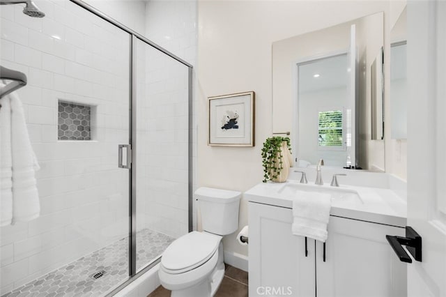 full bath with vanity, toilet, and a shower stall