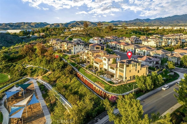 drone / aerial view featuring a residential view and a mountain view