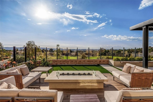 view of patio / terrace with an outdoor living space with a fire pit and fence