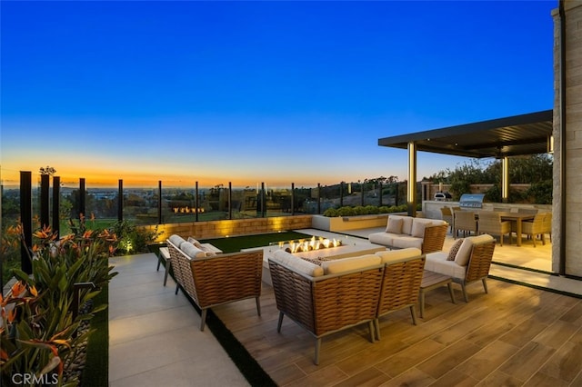 view of patio / terrace featuring an outdoor living space, a grill, an outdoor kitchen, and fence