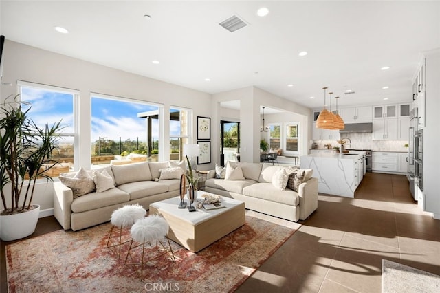 tiled living room with recessed lighting and visible vents