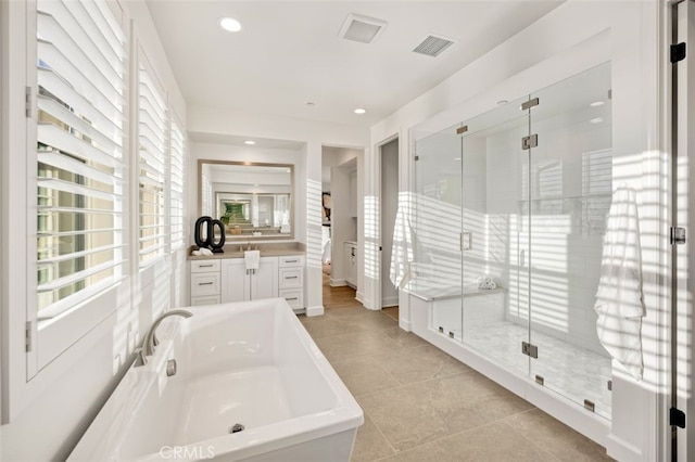 bathroom with visible vents, a bathing tub, recessed lighting, a shower stall, and vanity