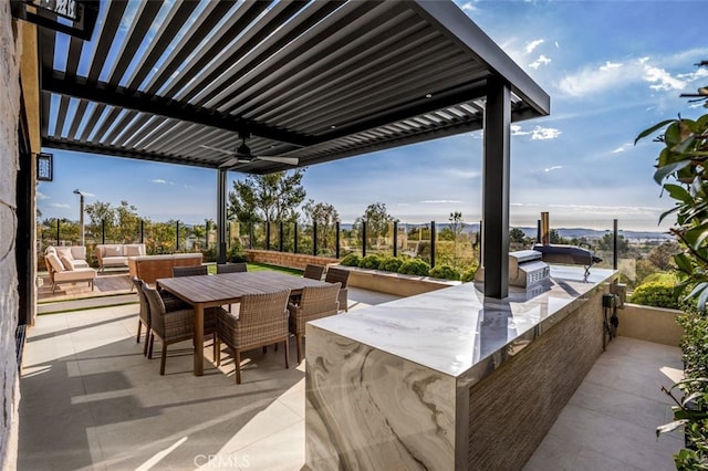 view of patio / terrace featuring an outdoor kitchen, outdoor dining area, a pergola, and an outdoor hangout area