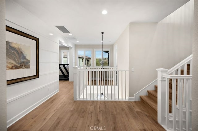 corridor with recessed lighting, baseboards, and wood finished floors