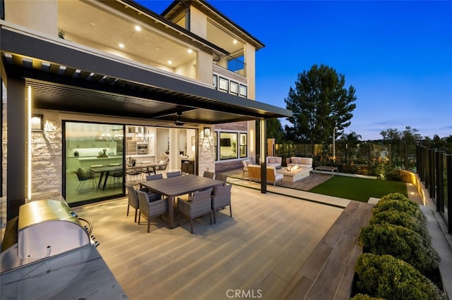 deck with outdoor dining space, outdoor lounge area, a ceiling fan, and fence