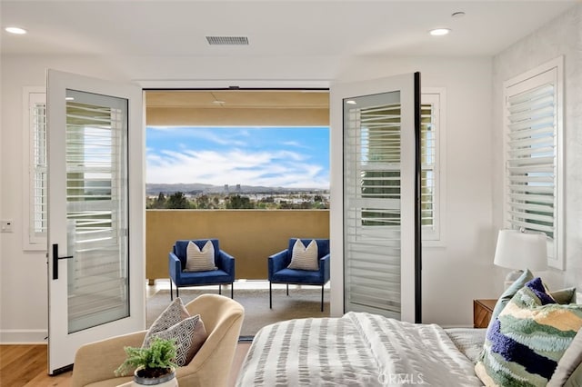 bedroom featuring wood finished floors, recessed lighting, and visible vents