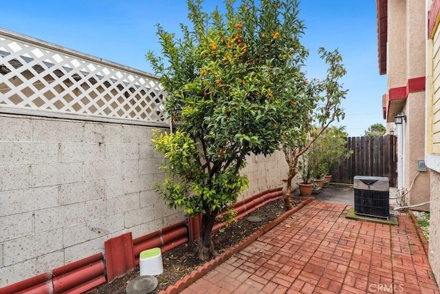 view of patio with cooling unit and a fenced backyard