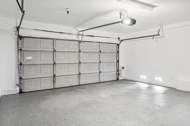 garage featuring a garage door opener and baseboards