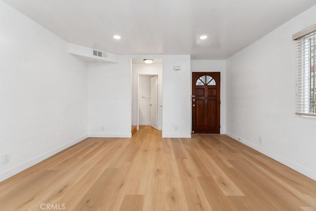 entrance foyer featuring visible vents, baseboards, and light wood-type flooring