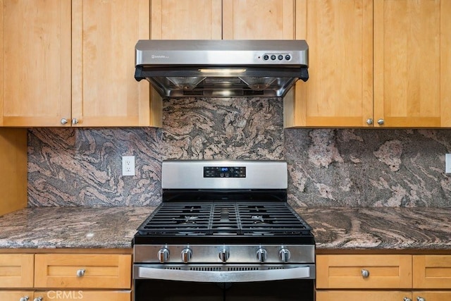 kitchen with light brown cabinetry, decorative backsplash, gas range, and ventilation hood