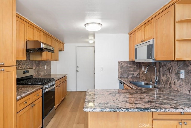 kitchen featuring stone counters, open shelves, a sink, extractor fan, and stainless steel gas range oven