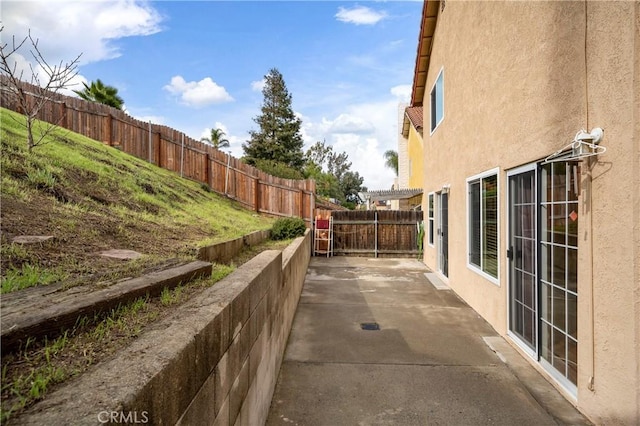 exterior space featuring a patio, a fenced backyard, and stucco siding